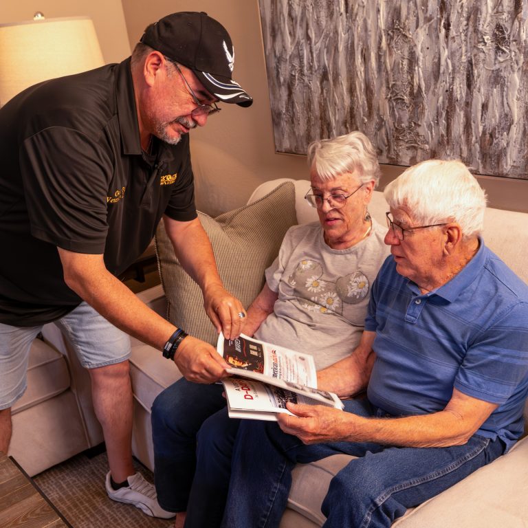 man showing book to senior citizens